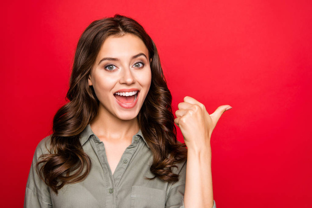 Leave feedback! Close up portrait of carefree, careless lady in casual outfit show thumb aside look at camera with open mouth isolated on bright red background with copy space for text - Fotoğraf, Görsel