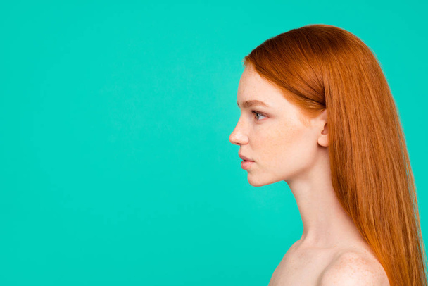 Profile side view of nude natural red-haired girl, shiny pure clean fresh smooth flawless skin, using vitamins, detox, collagen, botox effect isolated over green turquoise background, copy empty space - Photo, image