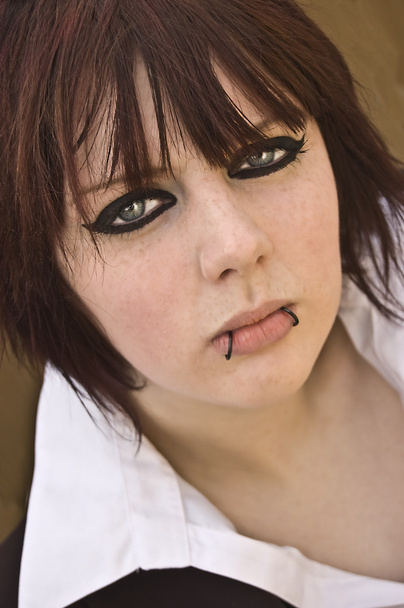 Woman with eyeliner and lip piercings - Photo, Image
