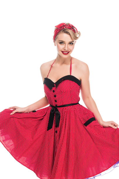 smiling young woman raising up pin up dress isolated on white  - Φωτογραφία, εικόνα