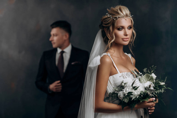 beautiful sexy blonde bride posing in wedding dress with her husband - Foto, immagini