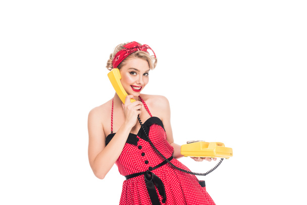 portrait of pretty woman in pin up dress talking on retro telephone isolated on white - Fotoğraf, Görsel