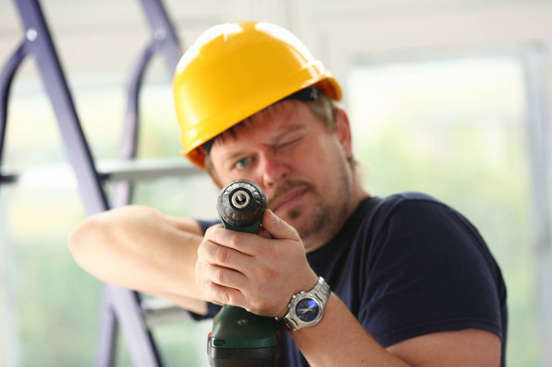 Arms of worker using electric drill closeup - Φωτογραφία, εικόνα