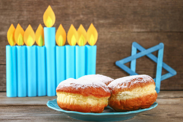 Jewish holiday Hanukkah and its attributes, menorah, donuts, Star of David - Fotó, kép