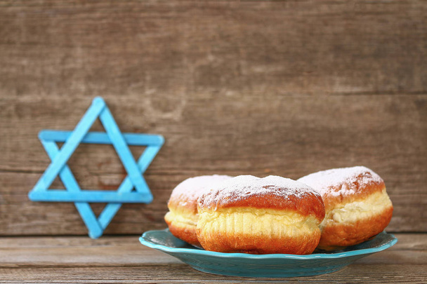 Jewish holiday Hanukkah and its attributes, menorah, donuts, Star of David - Foto, imagen