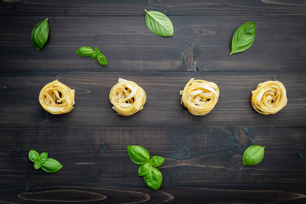 Ingredients for homemade pasta on dark wooden background. - Foto, Imagen
