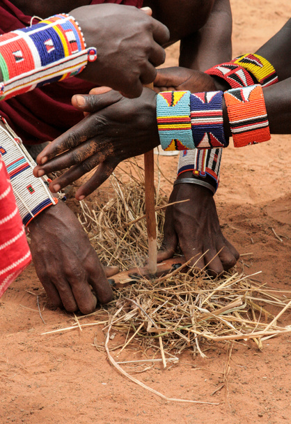 Kenya, Tsavo East - masai people setting the fire by their hands - Photo, Image