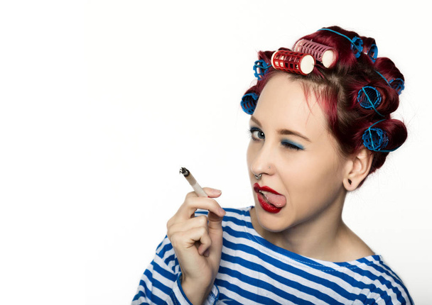funy housewife with curlers smokes a cigarette. smoking break for sexy lady. free space for your text - Фото, изображение