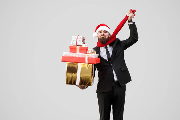 Bearded sadness businessman holding gift boxes and pulling scarf on his throat - Valokuva, kuva