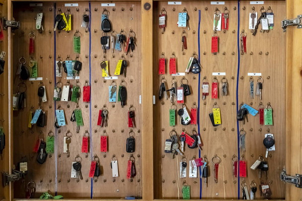 Multiple keys hang in a garage or service station ready for pickup - Photo, Image