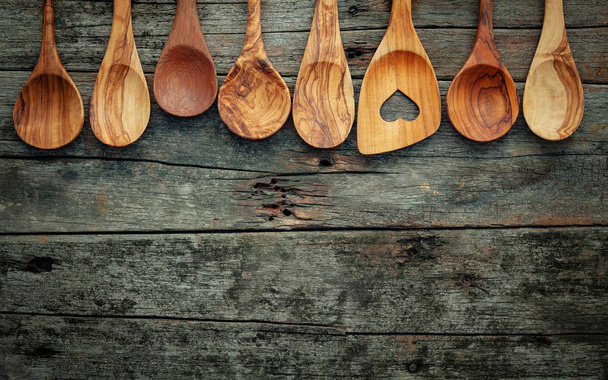 Various wooden cooking utensils on shabby wooden background . - Photo, Image