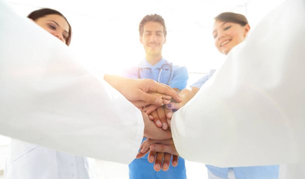 Doctors and nurses in a medical team stacking hands - Foto, imagen