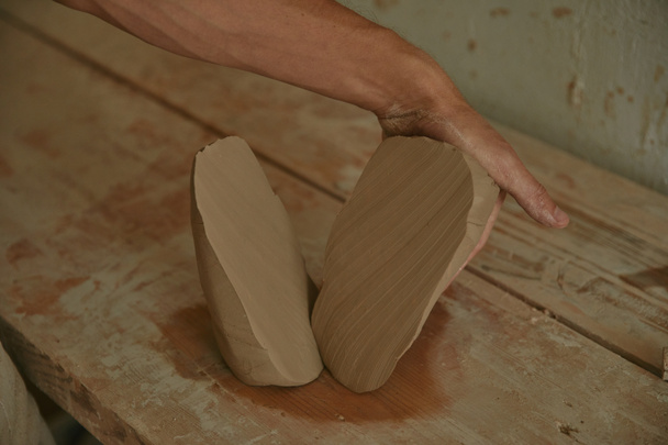 cropped image of professional potter working with clay at workshop  - Photo, Image