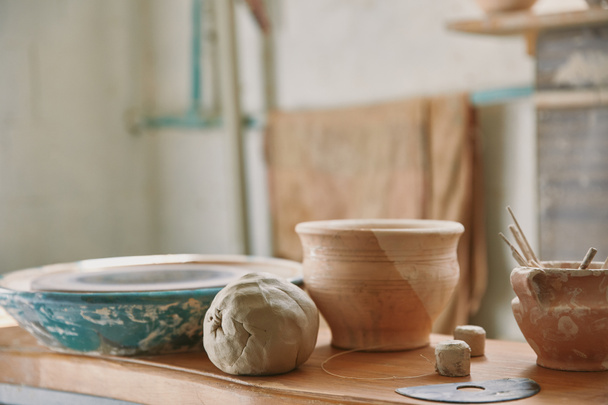 selective focus of clay and pottery tools at table in workshop  - Photo, Image