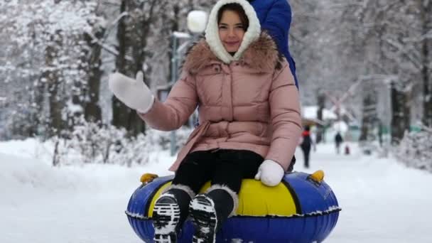 young girl rolling on tubing in the park in winter. - Footage, Video