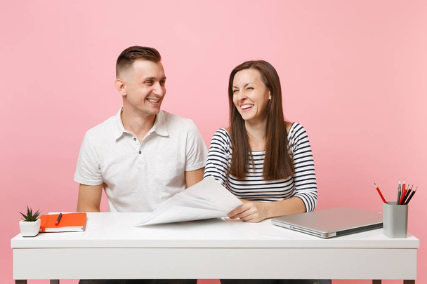 Two young smiling business woman man colleagues sit work at white desk with contemporary laptop isolated on pastel pink background. Achievement career concept. Copy space advertising youth co working - Photo, Image