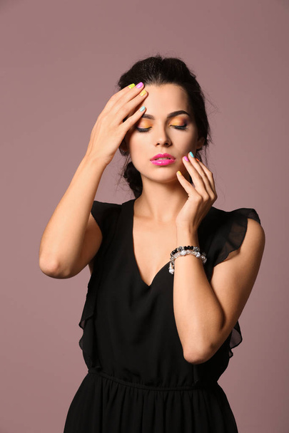 Beautiful young woman with professional manicure on color background - Valokuva, kuva