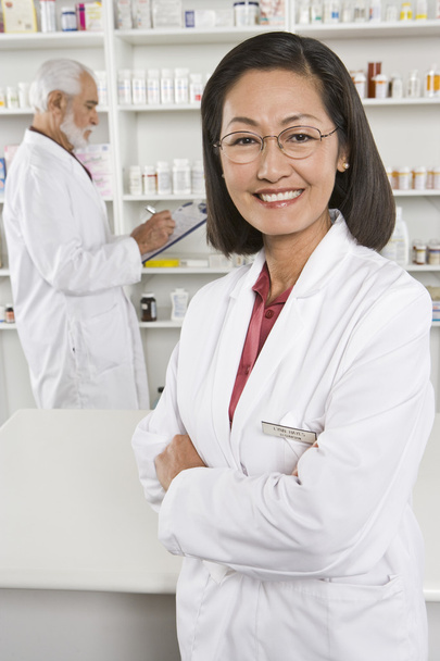 Confident Female Pharmacist Standing With Coworker - Foto, Imagem