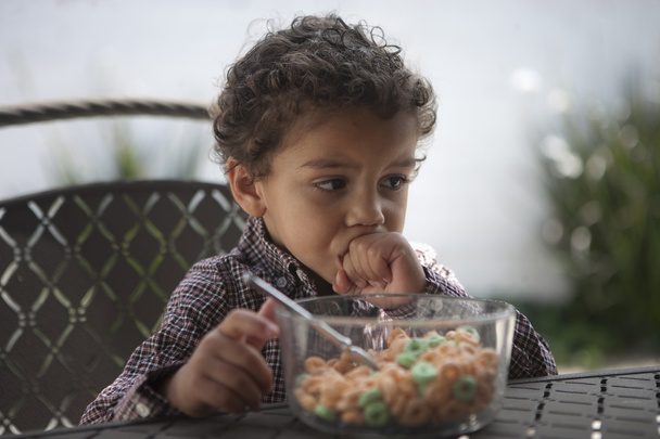 Pensive little boy with cereal bowl  - Foto, Imagen