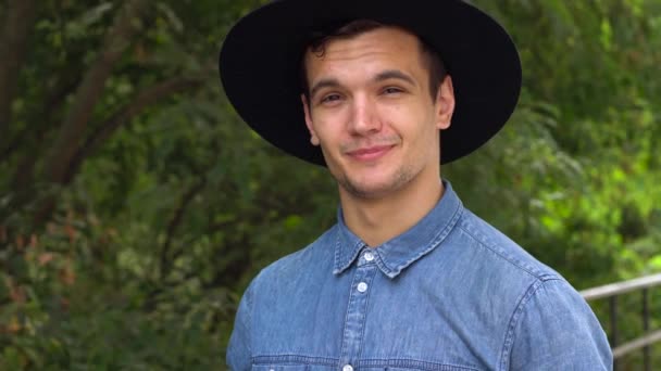 Young hipster man in hat laughing, relaxed in front of the camera - Footage, Video