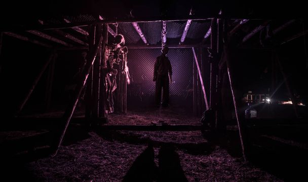 Horror vista silhouette di uomo impiccato sul patibolo di notte con nebbia e luce tonica su sfondo. Decorazione di esecuzione (o suicidio). Horror concetto di Halloween
. - Foto, immagini