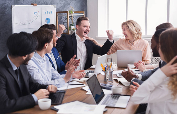 Business people congratulate colleague with his success - Фото, зображення