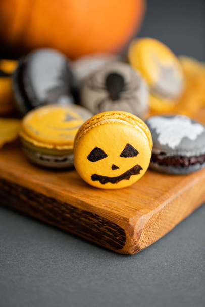 Halloween scary cookies with pumpkin on wooden cut board. pattern Bat , patina, ghosts and spiders. Gray color background, - Фото, зображення