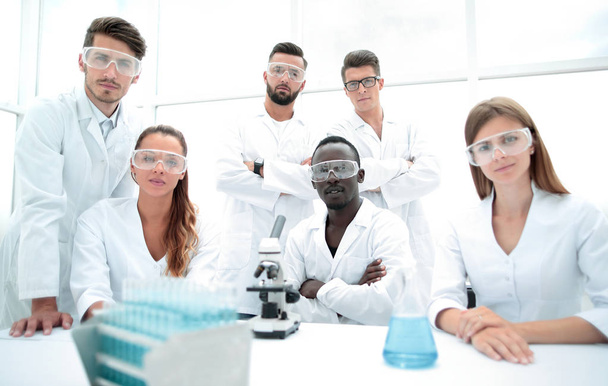 Group of young successful scientists posing for camera - 写真・画像