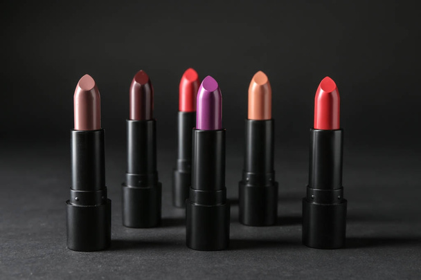 Colourful lipsticks on black background - Foto, Imagen