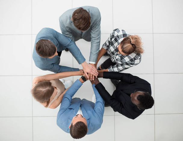 Top view of people putting hands together - 写真・画像