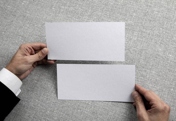 Mens hands holding empty white flyers - Foto, Bild