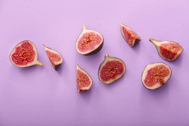 Cut ripe figs on color background - Zdjęcie, obraz
