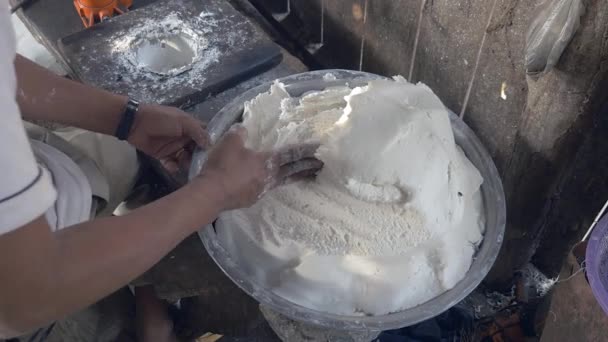 Close-up on man filling noodle pressing machine with rice dough - Footage, Video