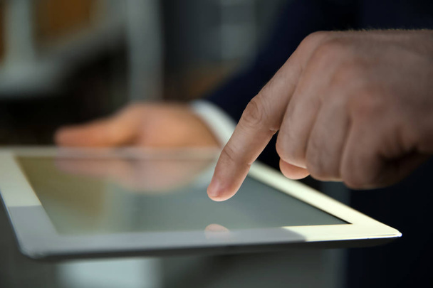 Businessman using digital tablet at workplace, closeup of hand. Mockup for design - Valokuva, kuva