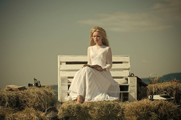 Girl in straw wreath and white dress on sunny day - Photo, Image