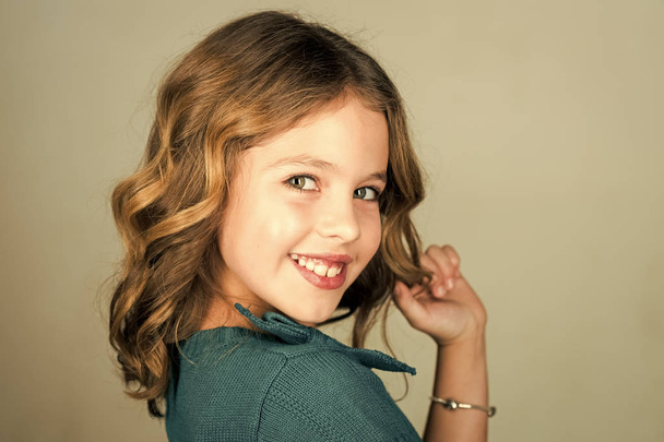 A happy little girl on the grey background - Φωτογραφία, εικόνα