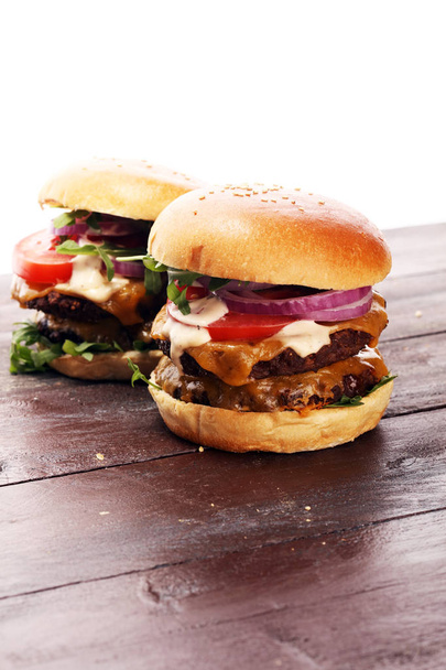 Tasty fresh meat burgers with salad and cheese. Homemade angus burger - Photo, image