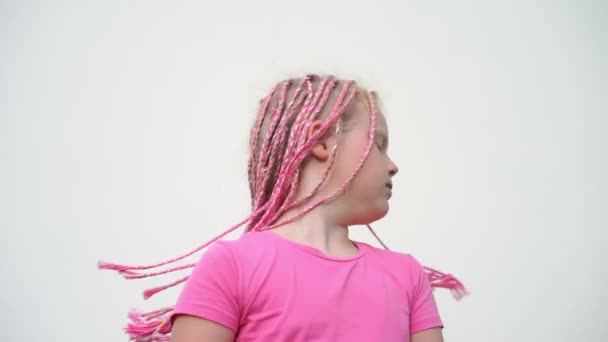 the beauty of slow motion - portrait of a beautiful light-skinned little girl of a non-standard modern appearance - with pink African plaits of zizi - Footage, Video