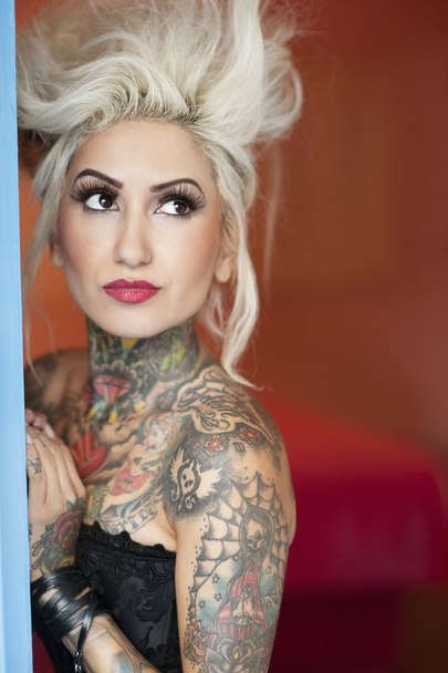 Tattooed young woman looking away - Photo, image