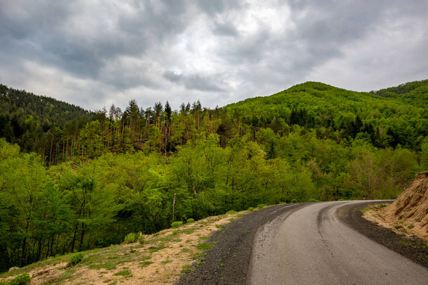 Perspective of black gravel mountain road - Zdjęcie, obraz