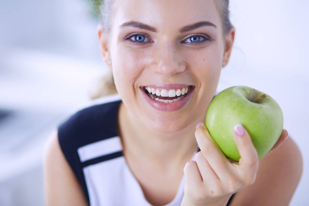 Close up portrait of healthy smiling woman with green apple. - Фото, изображение