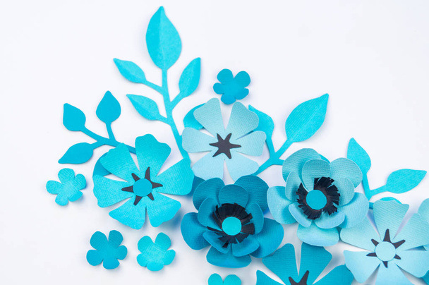 Flower and leaf of blue color made of paper. Handwork, favorite hobby. White background. - Foto, afbeelding