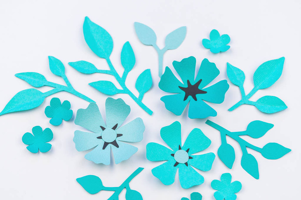 Flower and leaf of blue color made of paper. Handwork, favorite hobby. White background. - Photo, image