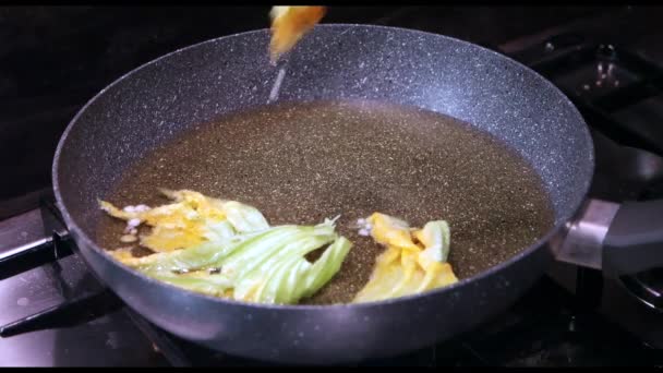 frying in a pan pumpink flowers - Footage, Video