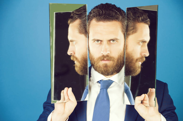business man with beard, holding mirror with face reflection - Φωτογραφία, εικόνα