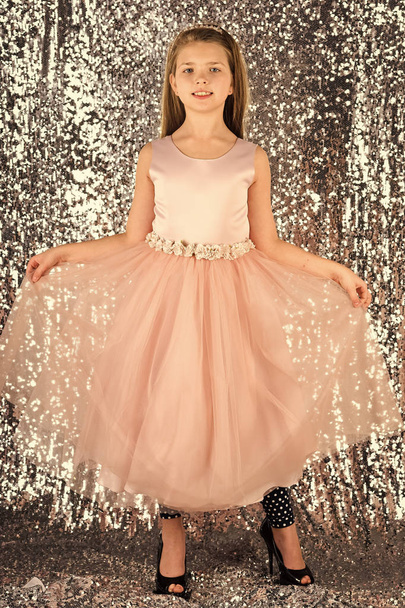 Little girl in fashionable dress, prom. Fashion model on silver background, beauty. Fashion and beauty, little princess. Look, hairdresser, makeup. Child girl in stylish glamour dress, elegance. - Photo, image