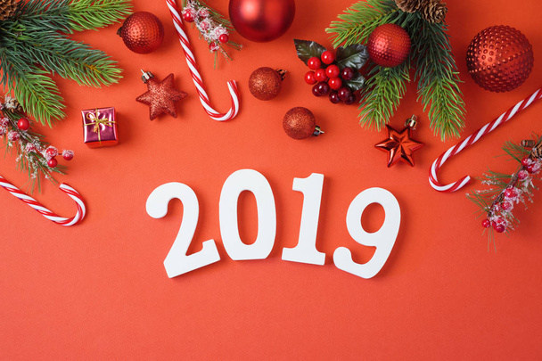 Christmas holiday background with 2019 new year, decorations and ornaments on red table. Top view from above. Flat lay - Valokuva, kuva