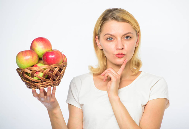 Apple recipes to make this fall. Girl hold basket apples white background. Culinary recipe concept. Woman thoughtful face come up with idea what to cook. Easy culinary ideas. Apple main ingredient - Fotoğraf, Görsel