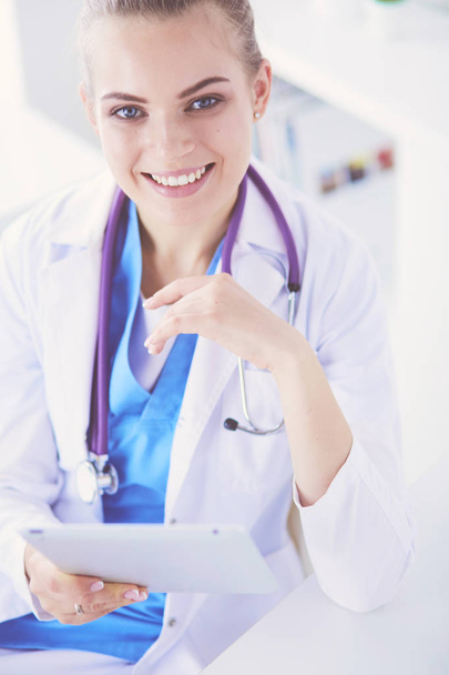 Close up Portrait of friendly female doctor with stethoscope and tablet in hands. - Фото, изображение