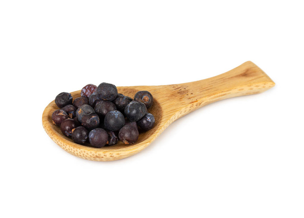 Dried juniper berries in wooden spoon isolated on white background. - Photo, Image